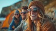 © Алина Бузунова - A group of friends laughing and enjoying drinks outside at the beach at autumn. A camping tent was in the background