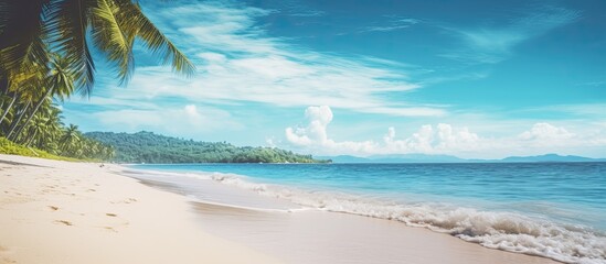 Wall Mural - Scenic tropical beach scene with a clear blue sky and fluffy white clouds; ideal for vacation and travel themes. Vintage filter style with copy space image.