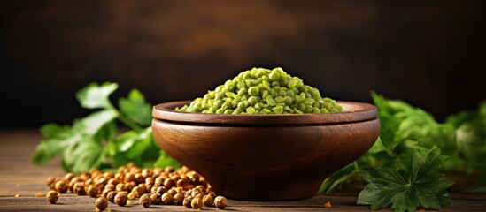 Aufkleber - Wooden bowl with green moong dal, a copy space image against a wooden background.