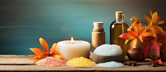 Poster - Autumn spa still life setting with plant, bath salt on wood backdrop. Features assorted essential oil and sea salt with copy space image, promoting fall wellness and aromatherapy theme.