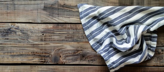 Poster - Top view of a striped napkin laid on a wooden surface with copy space image.