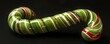 © Lal - A classic green and red striped candy cane ornament, isolated on a black background.