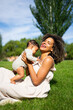 © Arianne - Happy afro mother with her baby in a park on a sunny day