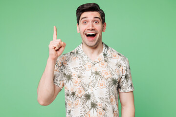 Wall Mural - Young insighted smart surprised fun proactive man he wear shirt casual clothes holding index finger up with great new idea isolated on plain pastel green background studio portrait. Lifestyle concept.