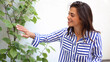 © PeopleVideos - Beautiful, young woman taking care of her houseplants and enjoying