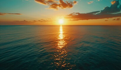 Wall Mural - beautiful sunset over the ocean with a blue sky, scenic view, calm seawater, drone aerial shot