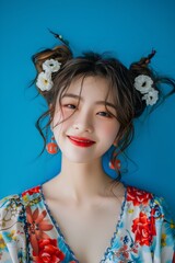 Wall Mural - Captivating Hallyu Woman in Modern Costume Smiling on Blue Background