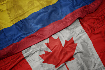 Wall Mural - waving colorful flag of colombia and national flag of canada on the dollar money background. finance concept.