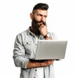 © Zaleman - An intelligent young bearded man holding a laptop and touching his beard