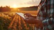 © Zaleman - A farmer or researcher holding a tablet may conduct research, analyze production, or monitor industry growth. On a countryside field, a farmer or researcher may display weather information,