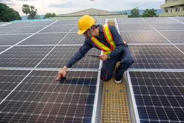 Wall Mural - a solar panel installation company employee assembles a photovoltaic system on the roof.