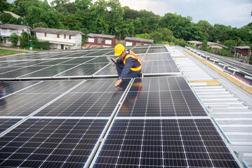 Wall Mural - a solar panel installation company employee assembles a photovoltaic system on the roof.