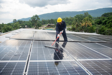 Wall Mural - cleaning staff solar panels are making up the photovoltaic system on the roof.