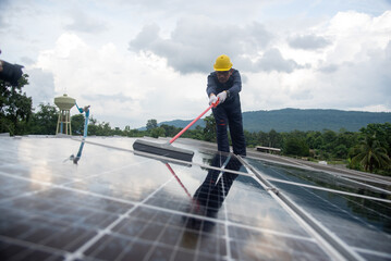 Wall Mural - cleaning staff solar panels are making up the photovoltaic system on the roof.