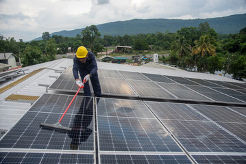 Wall Mural - cleaning staff solar panels are making up the photovoltaic system on the roof.