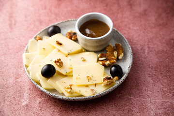 Wall Mural - Sliced cheese with nuts, grape and sauce