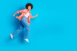 © deagreez - Full size photo of attractive young woman running hurry black friday dressed stylish checkered clothes isolated on blue color background