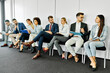 © Lumos sp - man business chair sitting waiting businessman candidate recruitment office businesswoman woman businessperson job young interview line employee career row hall colleague