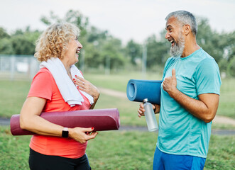 Wall Mural - woman man couple happy mature together active fit fitness park outdoor healthy talking leisure park love old nature bonding middle aged exercise mat yoga pilates