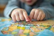 © RojOct - Child's Hands Pointing at World Map for Geography Lesson, Generative AI
