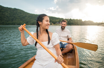 Wall Mural - Young couple enjoy time in nature on a boat