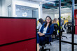 © GAJENDRRA BHATI  - Young indian professional woman sitting on chair smiling looking at camera in corporate office. workplace and business concept.