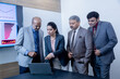 © GAJENDRRA BHATI  - Indian senior businessman with his colleagues discussing About Company Business Growth Using Laptop. finance, analysis and workplace concept.