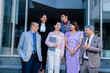 © GAJENDRRA BHATI  - Group of indian corporate businesspeople standing outside office. Company staff members in row looking at camera showing unity and laughing.