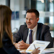 © peerapong - sleek, modern office,a client sits across from a fund manager, discussing their financial goals and investment strategies. The fund manager, dressed in sharp suit,listens attentively, taking analyzing