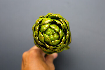 Wall Mural - Purple artichoke on dark background.