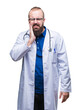 © Krakenimages.com - Young caucasian doctor man wearing medical white coat over isolated background touching mouth with hand with painful expression because of toothache or dental illness on teeth. Dentist concept.
