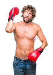 Sticker - Handsome hispanic boxer man wearing boxing gloves over isolated background sticking tongue out happy with funny expression. Emotion concept.