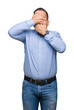 © Krakenimages.com - Middle age arab business man over isolated background Covering eyes and mouth with hands, surprised and shocked. Hiding emotion