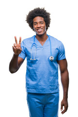 Wall Mural - afro american surgeon doctor man over isolated background showing and pointing up with fingers numbe