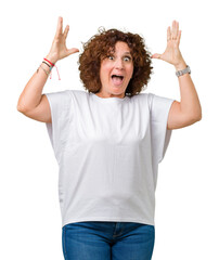 Poster - Beautiful middle ager senior woman wearing white t-shirt over isolated background celebrating crazy and amazed for success with arms raised and open eyes screaming excited. Winner concept