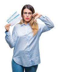 Canvas Print - Young beautiful woman holding boarding pass over isolated background with angry face, negative sign showing dislike with thumbs down, rejection concept