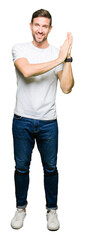 Sticker - Handsome man wearing casual white t-shirt Clapping and applauding happy and joyful, smiling proud hands together