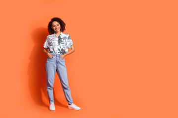 Wall Mural - Photo portrait of attractive model girl in jeans and stylish hawaiian trendy shirt posing at black friday season sale isolated on orange color background