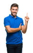 © Krakenimages.com - Young handsome man over isolated background with a big smile on face, pointing with hand and finger to the side looking at the camera.