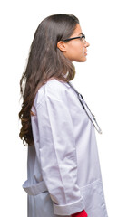 Sticker - Young arab doctor woman over isolated background looking to side, relax profile pose with natural face with confident smile.