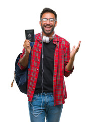 Canvas Print - Adult hispanic student man holding passport of america over isolated background very happy and excited, winner expression celebrating victory screaming with big smile and raised hands