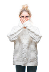 Canvas Print - Young beautiful blonde woman wearing glasses over isolated background shocked covering mouth with hands for mistake. Secret concept.