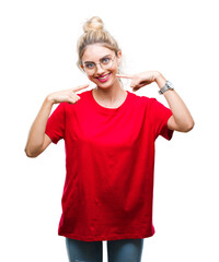 Canvas Print - Young beautiful blonde woman wearing red t-shirt and glasses over isolated background smiling confident showing and pointing with fingers teeth and mouth. Health concept.