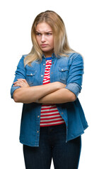 Poster - Young caucasian woman over isolated background skeptic and nervous, disapproving expression on face with crossed arms. Negative person.