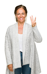 Sticker - Beautiful middle age adult woman wearing winter sweater over isolated background showing and pointing up with fingers number three while smiling confident and happy.