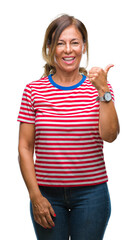 Sticker - Middle age senior hispanic woman over isolated background doing happy thumbs up gesture with hand. Approving expression looking at the camera with showing success.