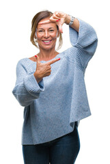 Poster - Middle age senior hispanic woman wearing winter sweater over isolated background smiling making frame with hands and fingers with happy face. Creativity and photography concept.