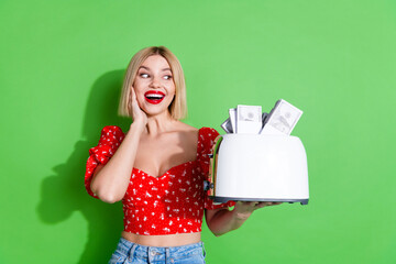 Sticker - Photo of amazed excited girl impressed look toaster with money dollars isolated green color background