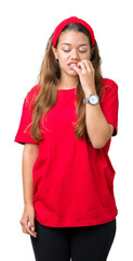 Sticker - Young beautiful brunette woman wearing red t-shirt over isolated background looking stressed and nervous with hands on mouth biting nails. Anxiety problem.