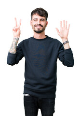 Wall Mural - Young handsome man over isolated background showing and pointing up with fingers number seven while smiling confident and happy.